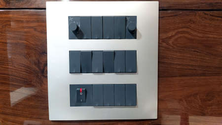 black color electric switch on brown boardの写真素材