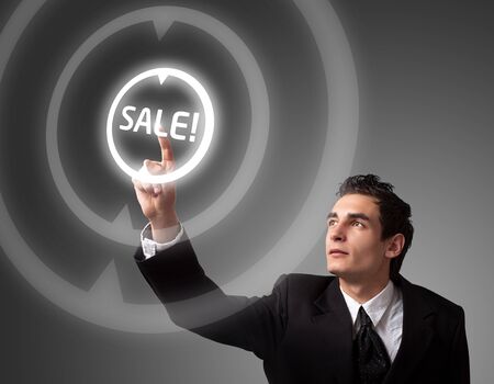business man pressing a SALE button の写真素材