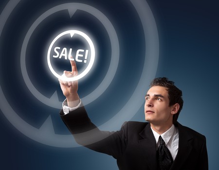 business man pressing a SALE button の写真素材