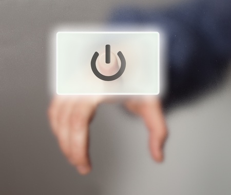 hand pressing ON/OFF buttonの写真素材