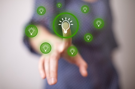 woman hand pressing light bulp buttonの写真素材