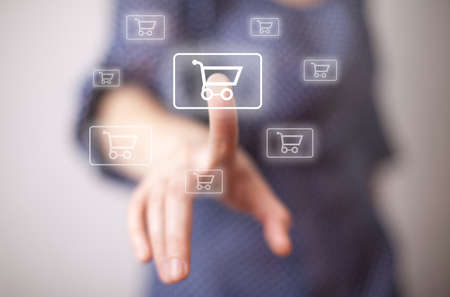 woman hand pressing shopping cart icon