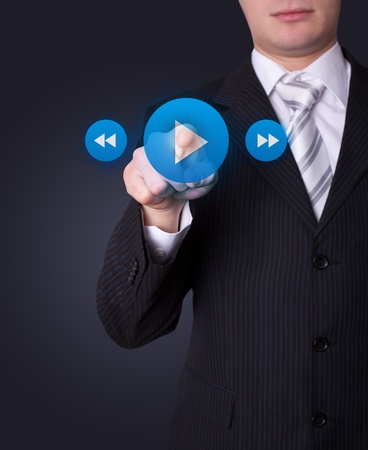 Man hand pressing media player buttonの写真素材