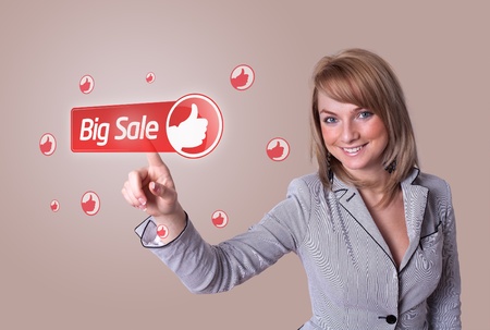 woman hand pressing BIG SALE buttonの写真素材