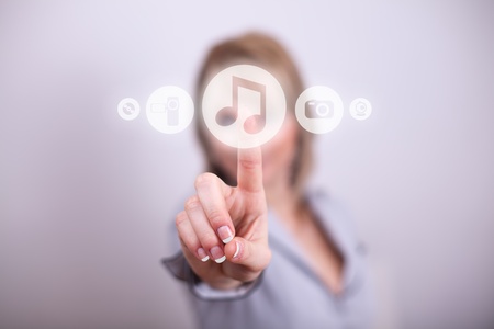 Woman pressing music button with one handの写真素材