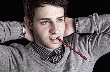 portrait of a young man with pencil の写真素材