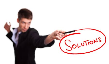 Businessman drawing solutions on whiteboard (selective focus)の写真素材