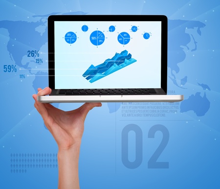 male hand holding a laptop, with modern diagrams and pie charts on tech backgroundの写真素材