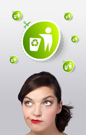 Young girl head looking at green eco signの写真素材