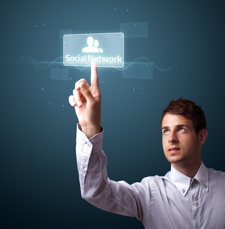 Businessman pressing modern social buttons on a virtual backgroundの写真素材