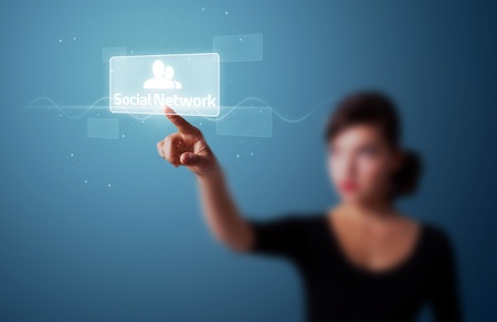Businesswoman pressing modern social buttons on a virtual backgroundの写真素材