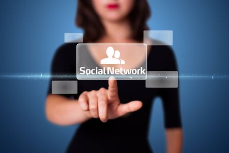 Businesswoman pressing modern social buttons on a virtual backgroundの写真素材