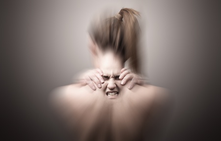 A nude back of a woman indicating neck pain の写真素材