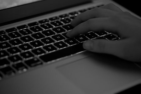 Woman hand typing on a keyboard