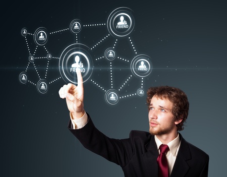 Businessman pressing modern social buttons on a virtual backgroundの写真素材