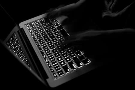 black computer keyboard with typing hands 