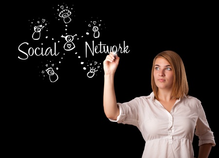 Young woman draving social network theme on whiteboardの写真素材
