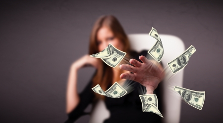 Beautiful young girl throwing moneyの写真素材