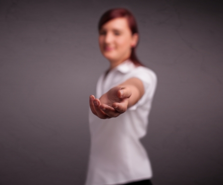 Pretty young girl holding somethingの写真素材
