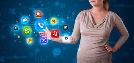 Young woman pressing various collection of high tech buttonsの写真素材