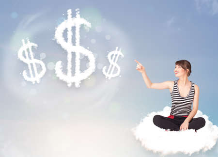 Pretty young woman sitting on cloud next to cloud dollar signsの写真素材