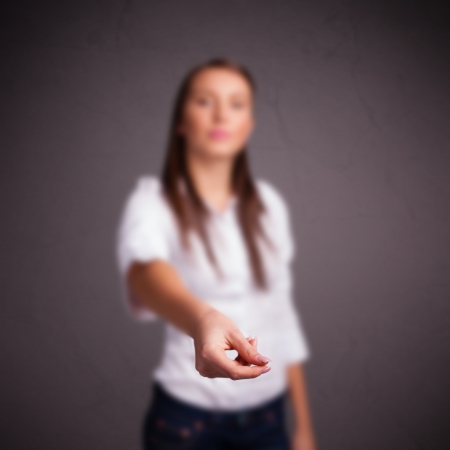 Pretty young girl holding somethingの写真素材