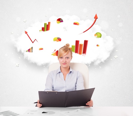 Beautiful young businesswoman with cloud in the background containing colorful graphs and diagramsの写真素材