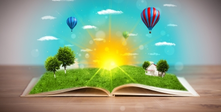 Open book with green nature world coming out of its pages, ecological conceptの写真素材