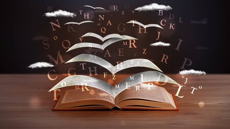Pages and glowing letters flying out of a book on wooden deckの写真素材