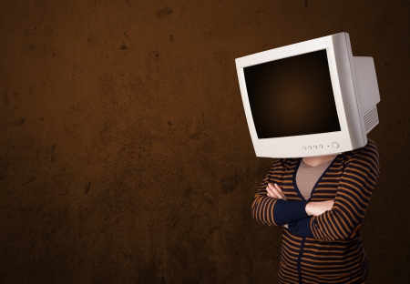 Girl with a computer monitor on her head and empty brown copyspaceの写真素材