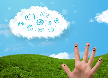 Happy cheerful smiley fingers looking at cloud with blue social icons and smybolsの写真素材