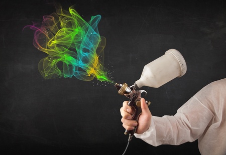 Painter working with airbrush and paints colorful paint conceptの写真素材