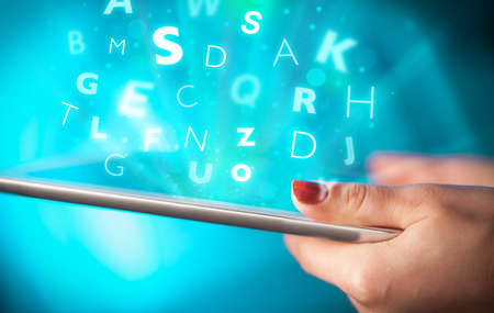 Hand touching tablet pc, letters conceptの写真素材
