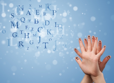 Happy cheerful smiley fingers looking at mixture of bokeh lettersの写真素材
