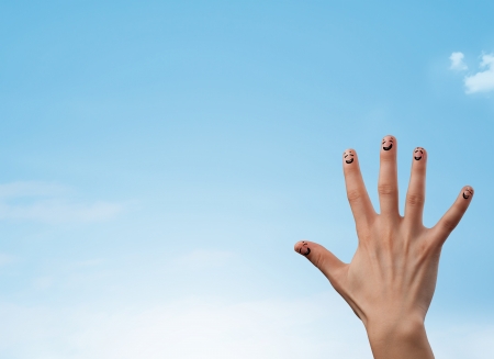 Happy cheerful smiley fingers looking at clear blue sky copyspaceの写真素材