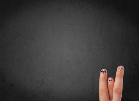 Happy finger smileys faces on hand with empty copy space dark backgroundの写真素材