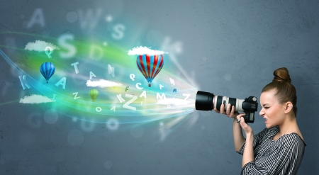 Cute photographer girl with camera and abstract imaginaryの写真素材