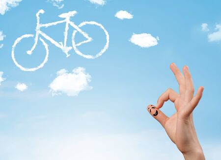 Happy cheerful smiley fingers looking at a bicycle shapeed cloudの写真素材