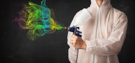 Painter working with airbrush and paints colorful paint conceptの写真素材