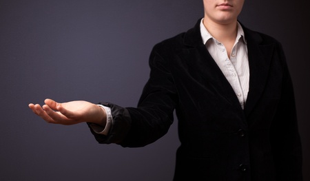 Businesswoman presenting empty spaceの写真素材