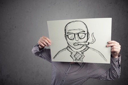 Businessman holding a cardboard with a smoking man on it in front of his headの写真素材