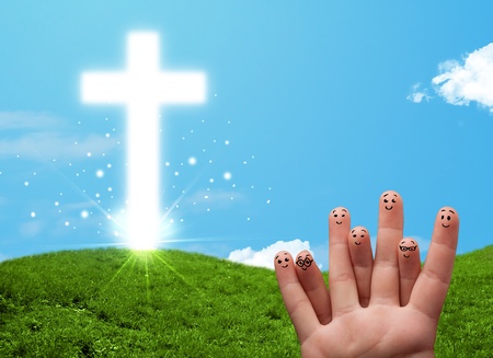 Happy finger smiley faces on hand with christian religion crossの写真素材