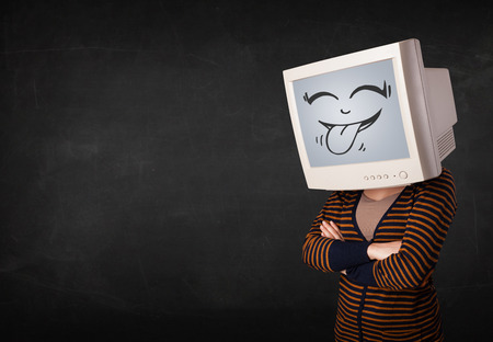 Young girl wearing a monitor with a funny face gestureの写真素材