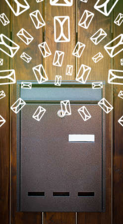 Mailbox with letter icons exploding on glowing green backgroundの写真素材