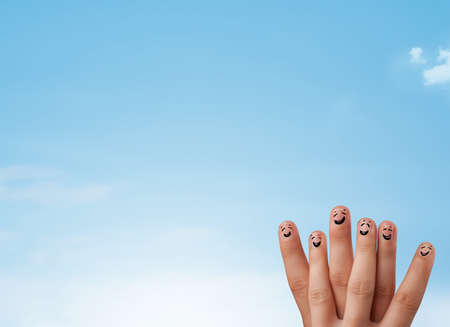Happy cheerful smiley fingers looking at clear blue sky copyspaceの写真素材