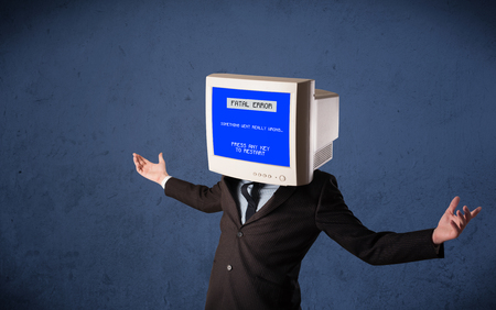 Person with a monitor head and fatal error blue screen on the displayの写真素材