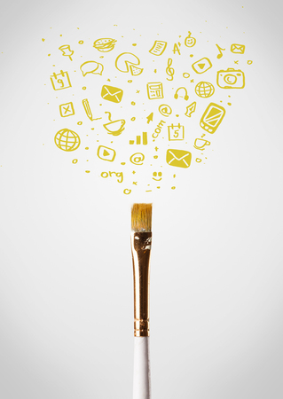 Paintbrush close-up with sketchy social media iconsの写真素材
