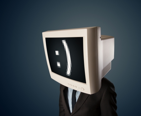Funny young businessman with a monitor on his head and smiley on the black screen