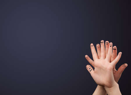 Happy cheerful smiley fingers looking at empty wall copyspaceの写真素材