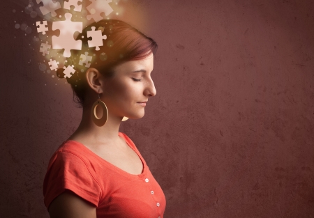 Young person thinking with glowing puzzle mind on grungy backgroundの写真素材